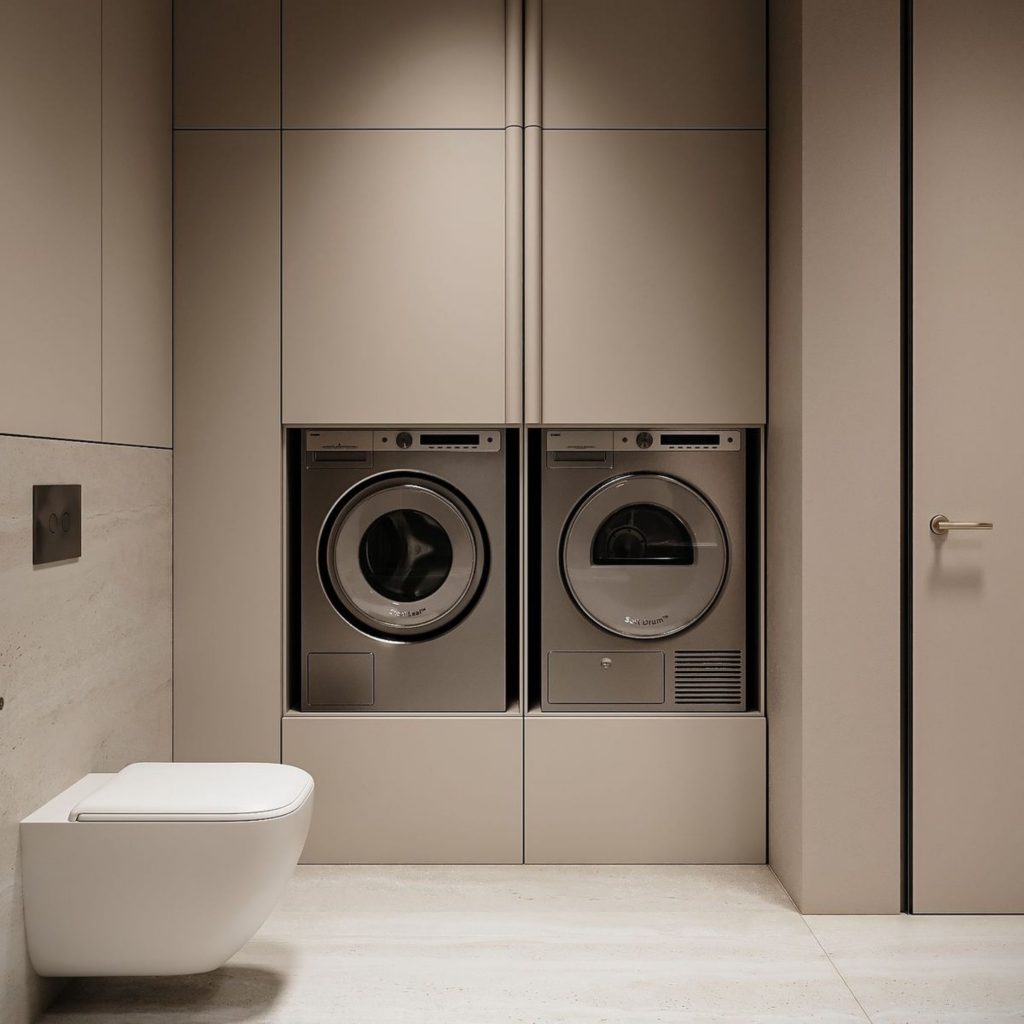 Lavandaria inserida na casa de banho, onde o design de interiores permitiu criar um espaço funcional, organizado e visualmente harmonioso.