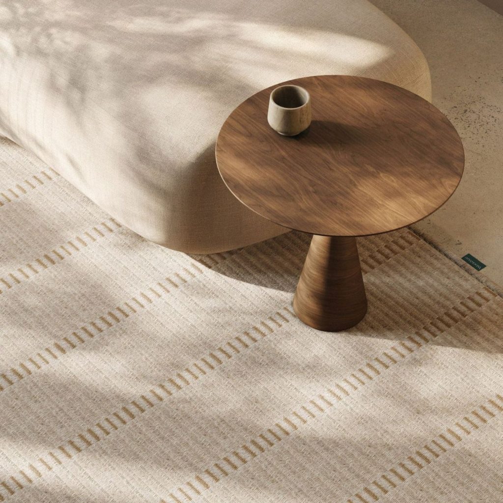 Ambiente minimalista onde a decoração se expressa através de formas suaves e materiais naturais, criando um espaço que desperta emoções de calma e proximidade. A luz suave revela a intenção da arquitetura em moldar atmosferas, reforçando como a decoração influencia o modo como habitamos o quotidiano. A presença discreta da mesa de apoio e do sofá curvo traduz uma abordagem sensorial, onde as emoções emergem da harmonia entre textura, proporção e silêncio, refletindo uma arquitetura pensada para acolher. A coerência da decoração reforça a ligação emocional ao espaço, permitindo que as emoções se alinhem com a intenção da arquitetura.