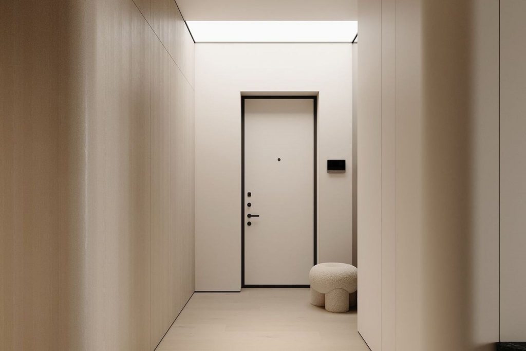 Um corredor minimalista onde os moveis para corredor se integram num ambiente sereno, criando uma decoração subtil que reforça a intenção de uma decoração para corredores limpa e contemporânea; o banco arredondado e a porta escura sugerem soluções de Decoração para corredor estreito que inspiram Ideias para decorar corredores estreitos, mostrando como moveis para corredor podem acrescentar textura num espaço onde a decoração privilegia tons neutros e a decoração para corredores valoriza simplicidade; a iluminação embutida destaca propostas de Decoração para corredor estreito e amplia novas Ideias para decorar corredores estreitos, enquanto os moveis para corredor se articulam com o pavimento claro, permitindo que a decoração respire e que a decoração para corredores ofereça referências de Decoração para corredor estreito, multiplicando Ideias para decorar corredores estreitos num cenário moderno e equilibrado.